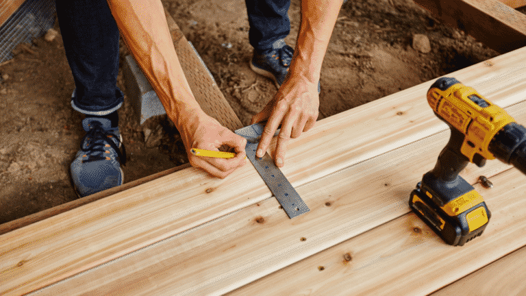 A builder makes a measurement using an L-square.