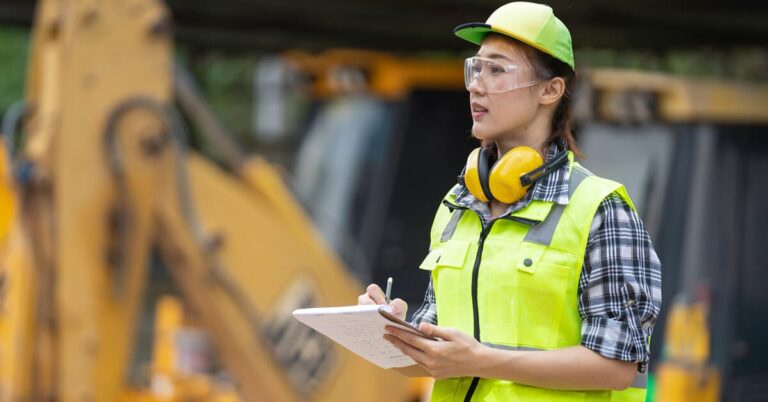 Builder taking notes on a construction site