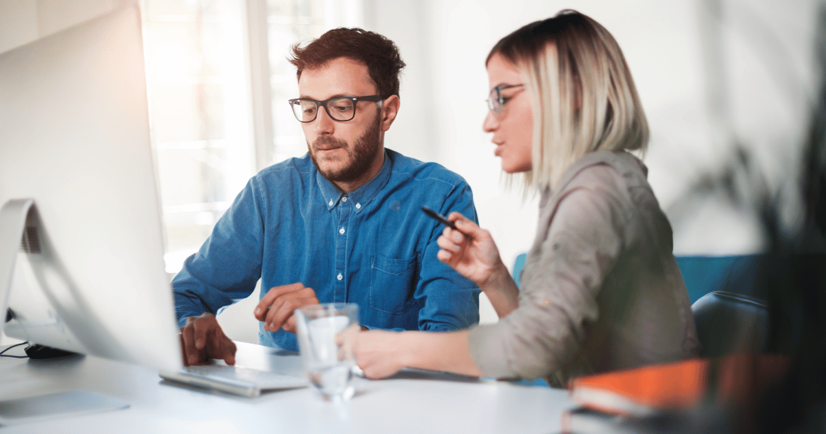 Customers sit a table in their home reviewing a builders web site.