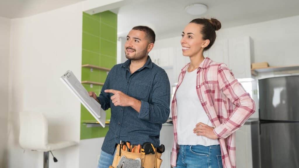 A builder and a homeowner discussing a custom home build project.