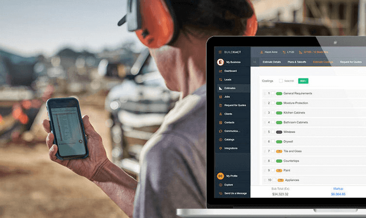Residential builder reviewing a construction cost estimate on a mobile device at a job site, alongside a laptop displaying Buildxact estimating software with itemized project costs.